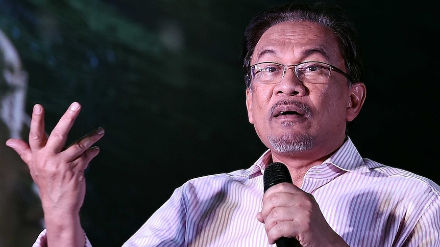 Malaysian opposition leader Anwar Ibrahim gestures while addressing his supporters