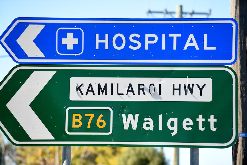 a sign for a country town on the side of a road