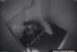 CCTV footage of a guard holding a female detainee down onto a bed