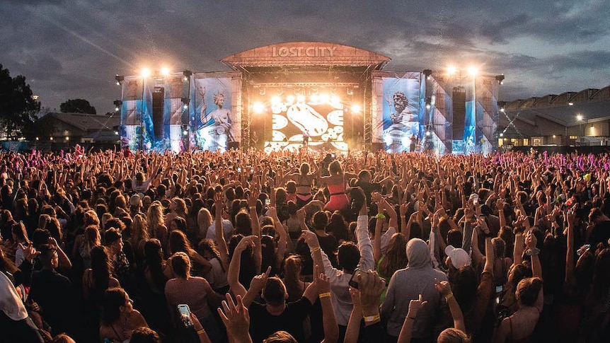 crowds in front of a lit up stage