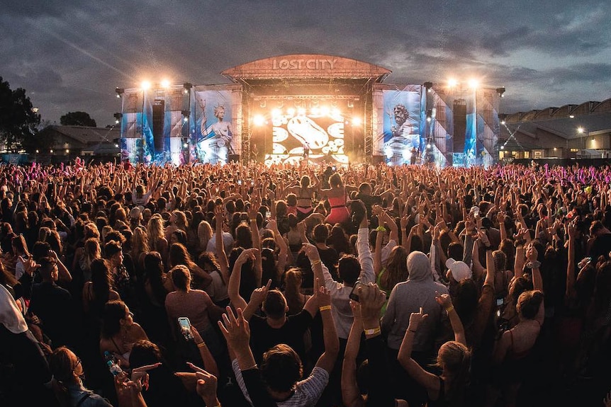 crowds in front of a lit up stage