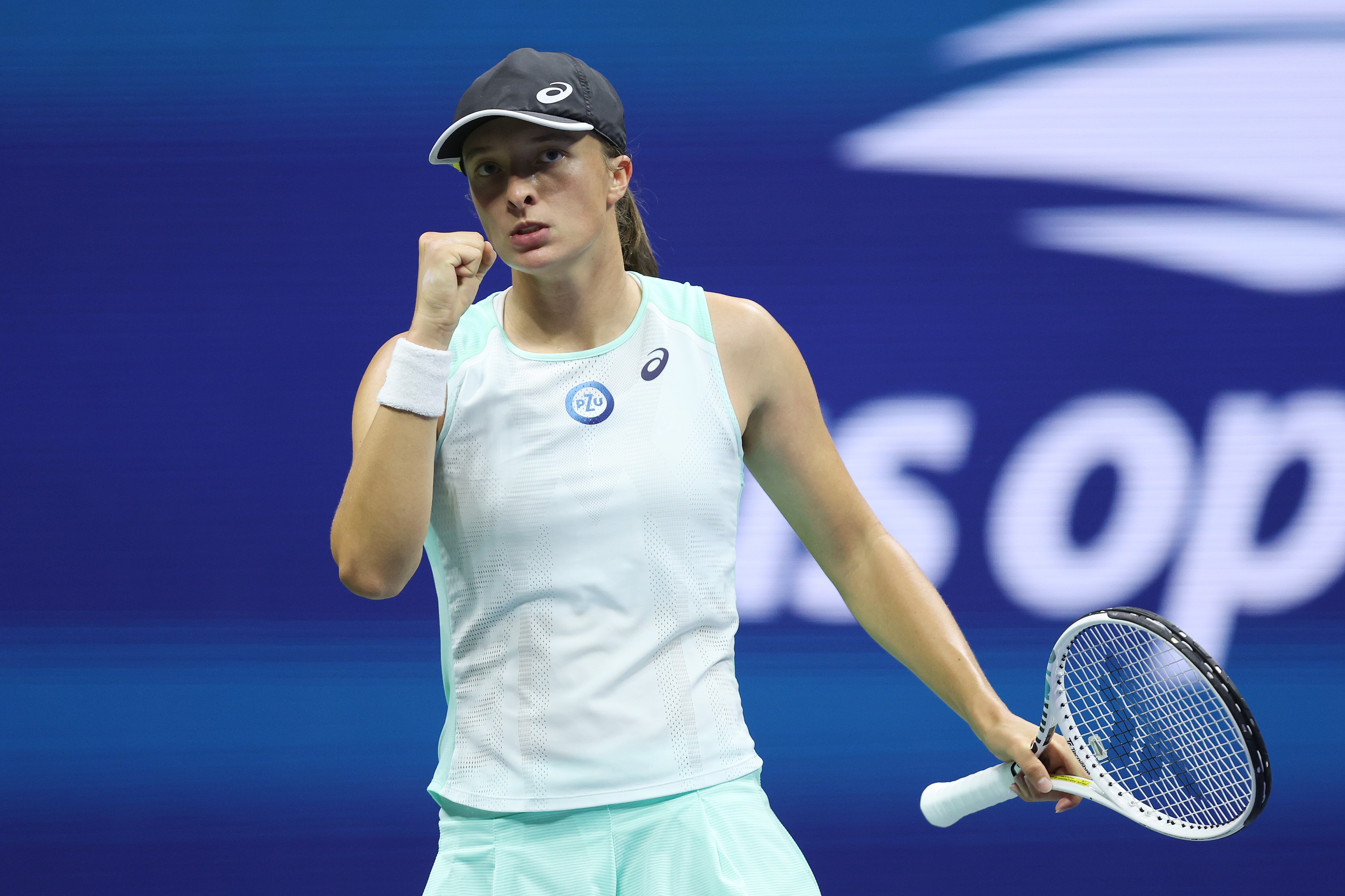 A Polish female tennis player pumps her right fist during a match at the US Open.
