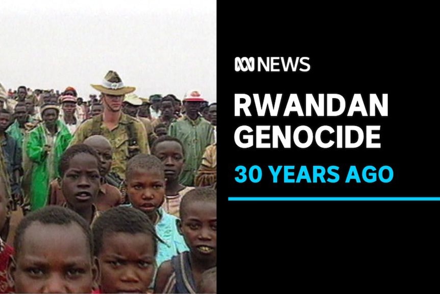 Rwandan Genocide, 30 years Ago: Rwandan children and adults look at camera with two Australian peacekeepers in crowd. 