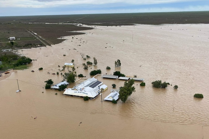 An aerial view of an outback pub surrounded by floodwater