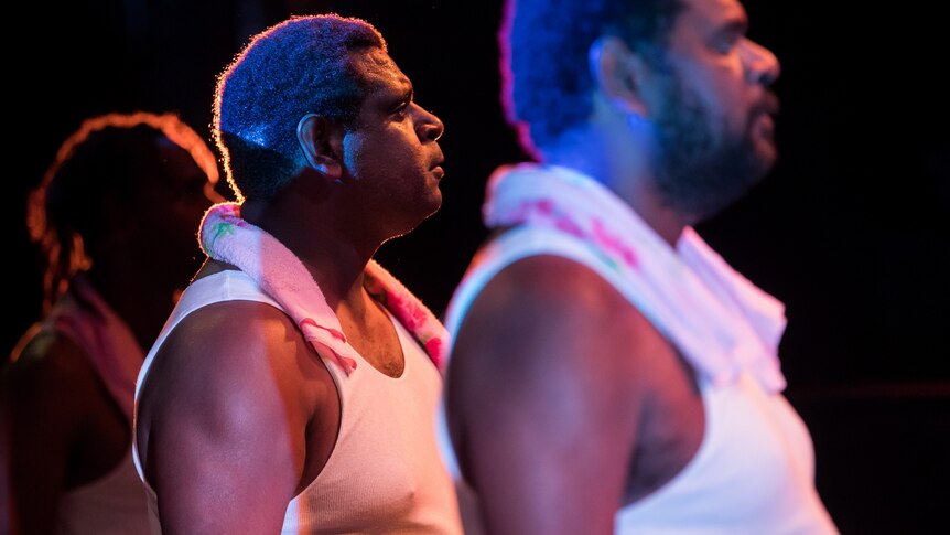 Production photograph of Jimi Bani on stage with his brothers Richard and Conwell.