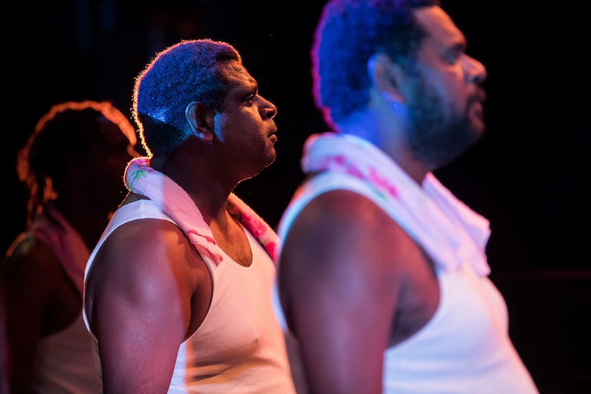 Production photograph of Jimi Bani on stage with his brothers Richard and Conwell.