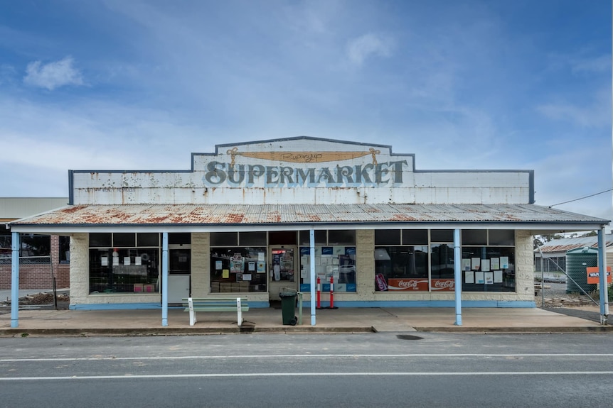 A large old supermarket building on a main street. The words 'Rupanyup Supermarket' are visible.