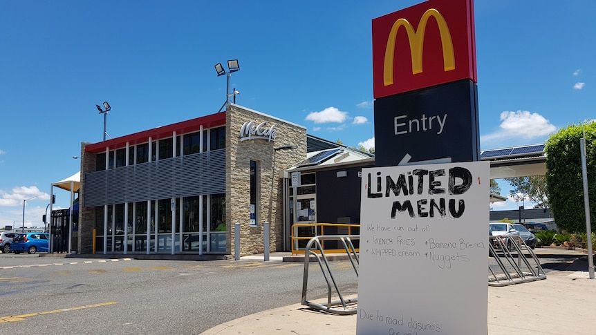 Signage about a limited menu outside a McDonald's.