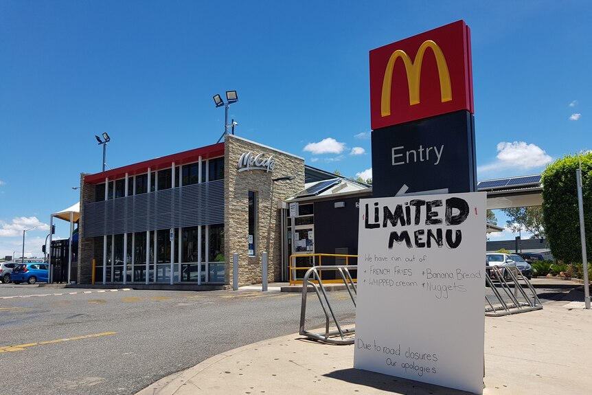 Signage about a limited menu outside a McDonalds.