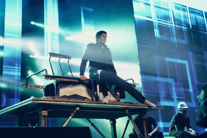 David Copperfield sitting on stage during one of his shows.
