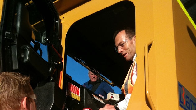 Tony Abbott  in the cab of an excavator