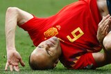 Spain's Andres Iniesta tumbles to the turf against Russia