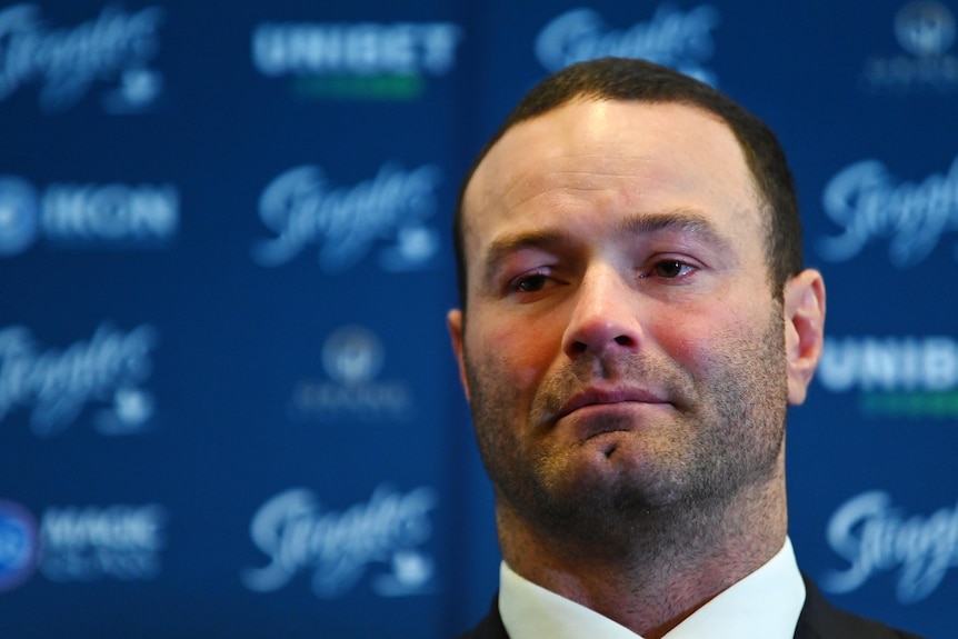 Emotional rugby league player Boyd Cordner stands in front of a microphone to announce his retirement.