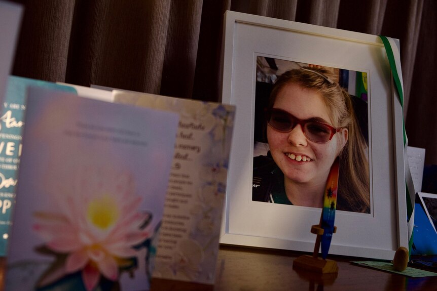 A photo of Tara Ingerson sits among sympathy cards. 