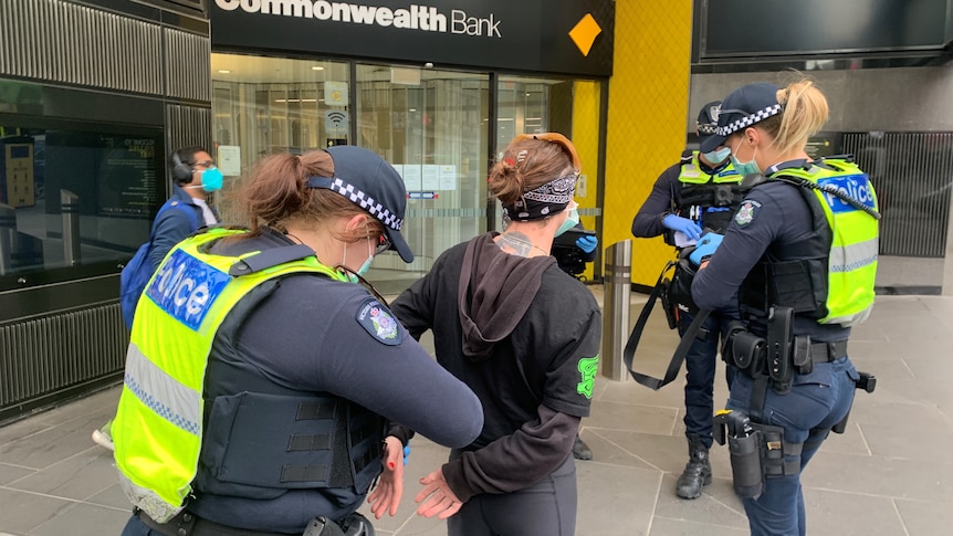 Police handcuffing a woman in Melbourne's CBD.