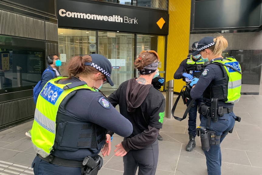 Police handcuffing a woman in Melbourne's CBD.