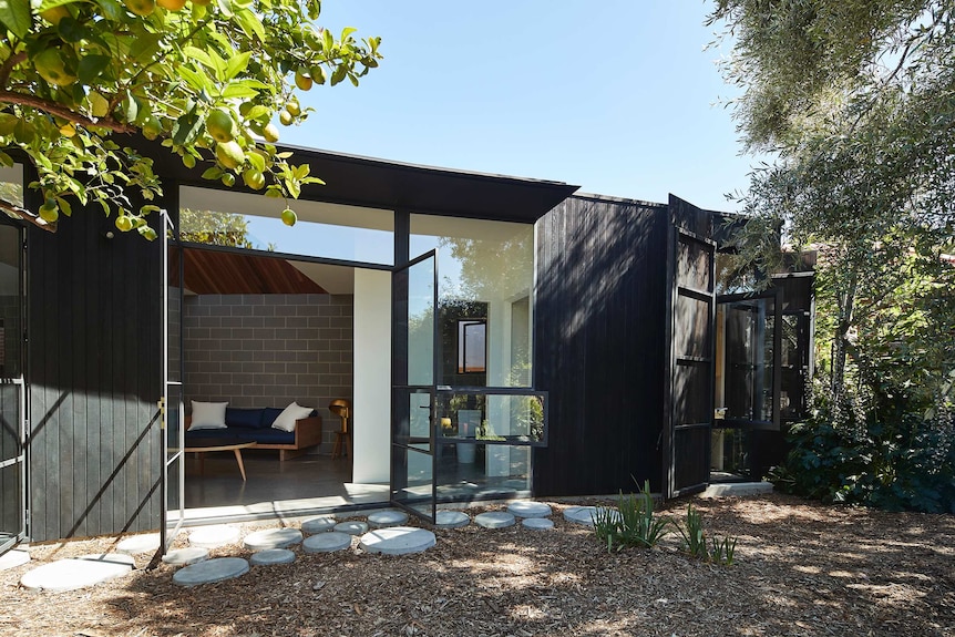 Exterior of a house with an overhanging lemon tree.