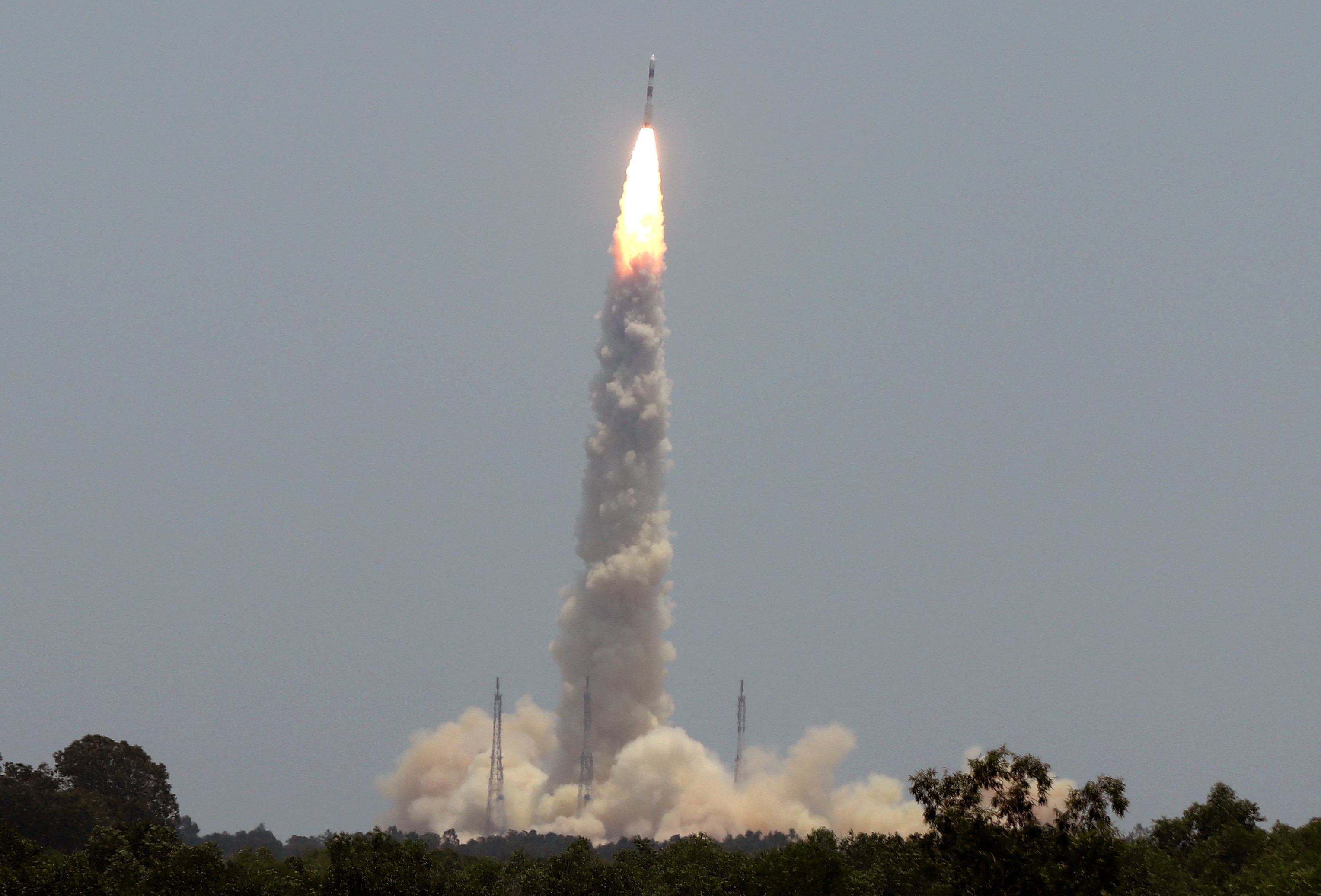 A cloud of smoke billows through the sky as a rocket takes off