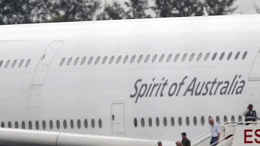Passengers disembark Qantas jet