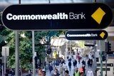 Commonwealth Bank sign above a crowd of people.
