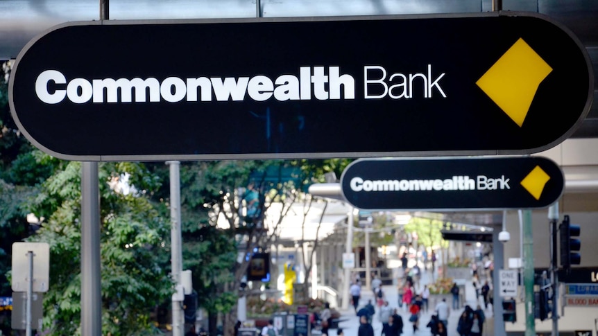 Commonwealth Bank sign above a crowd of people.