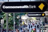 Commonwealth Bank sign above a crowd of people.