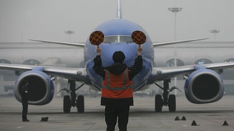 A plane sits at a foggy airport (Getty Images)