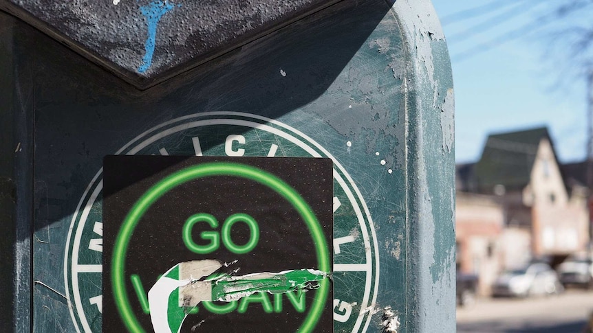 A 'Go Vegan" sticker with the vegan scratched off