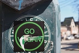 A 'Go Vegan" sticker with the vegan scratched off