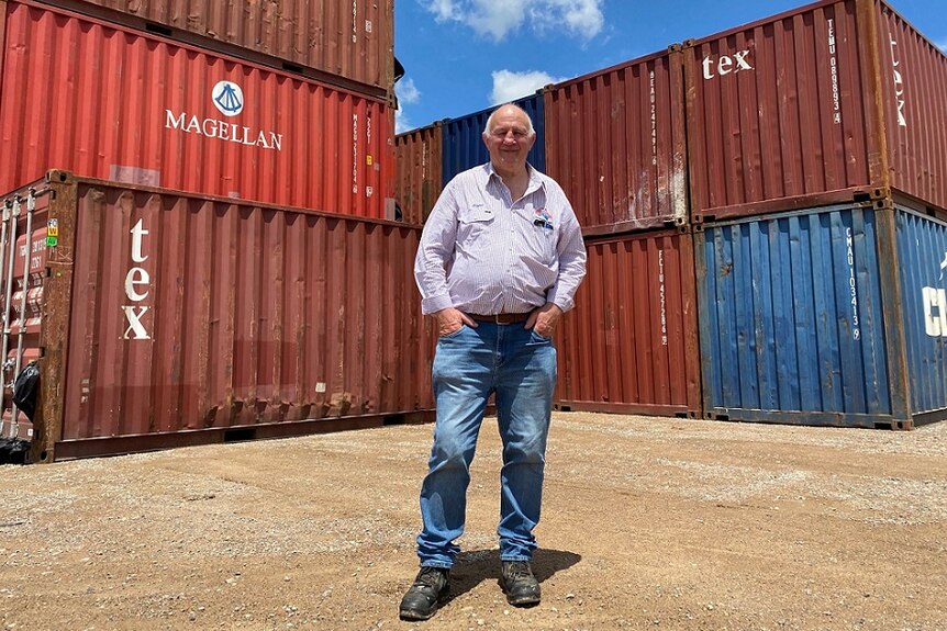 Roger Fletcher standing in front of containers