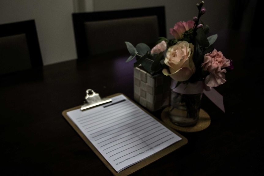 A table with a bouquet of flowers on it