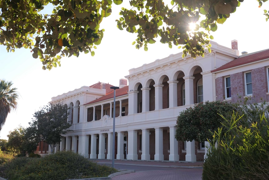 Geraldton Courthouse exterior framed by trees.