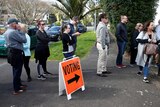 Voters wait outside a polling station at the St Heliers Tennis Club.