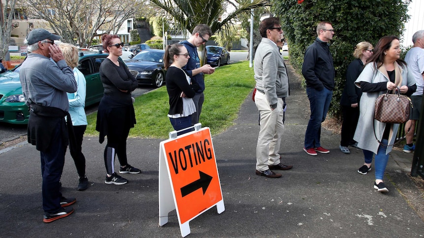 Voters wait outside a polling station at the St Heliers Tennis Club.