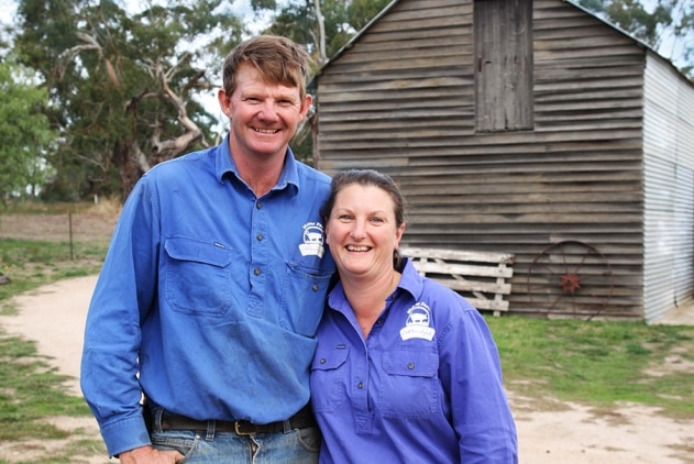 Belinda and Jason Hagan standing in front of a shed at their farm.