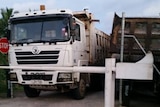 Protestors block the entrance to refugee accommodation on Manus Island with trucks