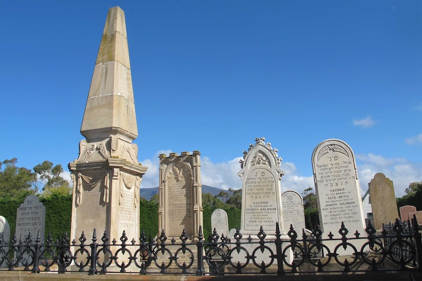 Four headstones in a burial plot in a Jewish grave yard.