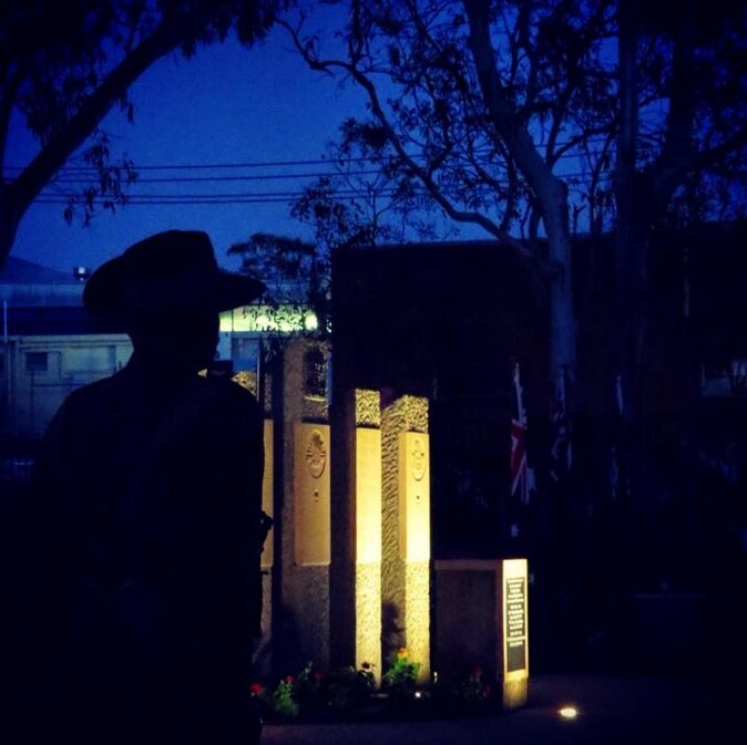 A soldier stands to attention during the Anzac Day dawn service in the Brisbane suburb of The Gap.