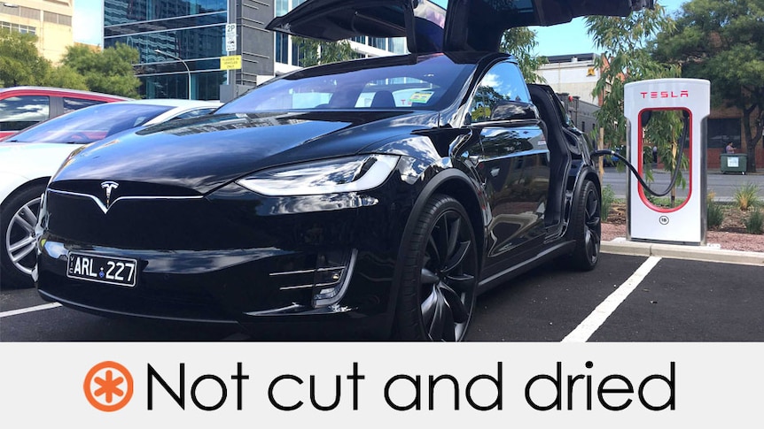 Tesla vehicle at a charging station. Stephen Conroy's claim is not cut and dried