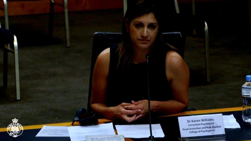Women sits at desk at NSW Parliament.