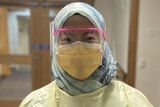 A female hospital worker wearing PPE.