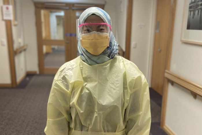 A female hospital worker wearing PPE.