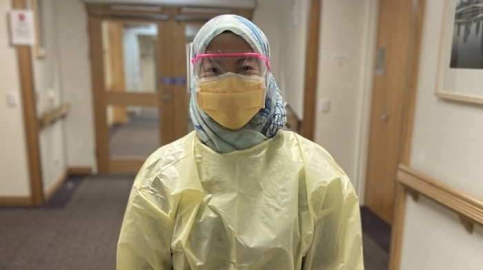 A female hospital worker wearing PPE.