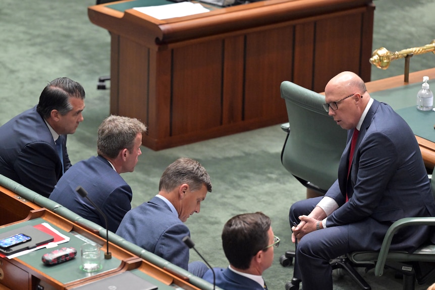 Peter Dutton consulting the frontbench during Question Time