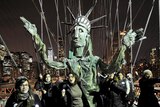 Occupy Wall Street supporters carry a puppet of the Statue of Liberty across the Brooklyn Bridge.