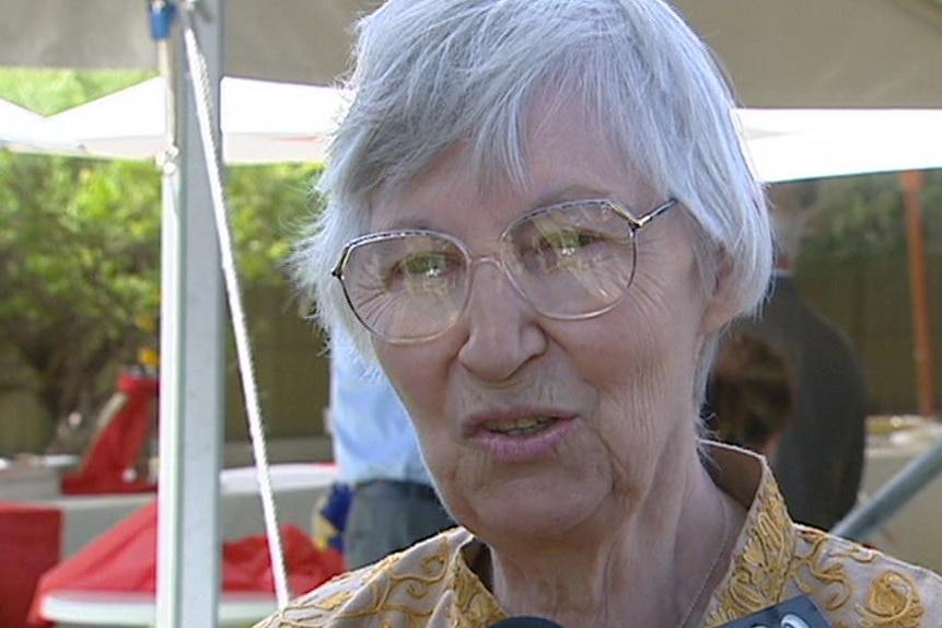 An elderly woman with large glasses
