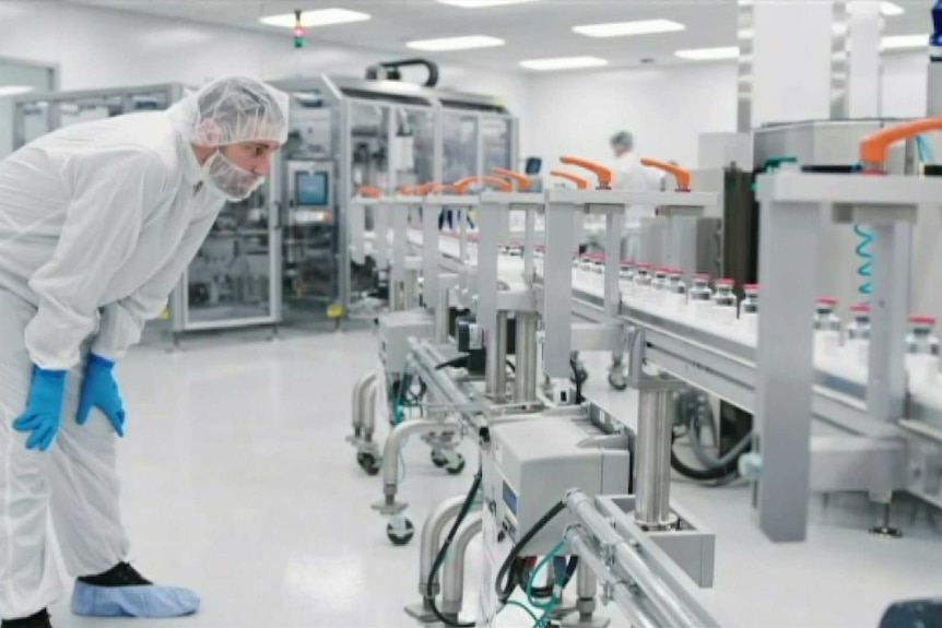 A researcher wearing protective clothing in a lab.
