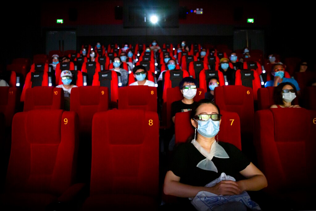 People wearing face masks sit in a cinema in China.