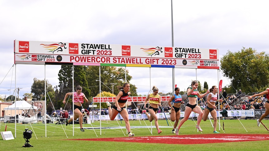 A group of women running on a race track