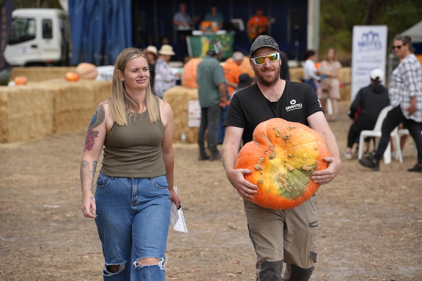 a man carrying a pumpkin 